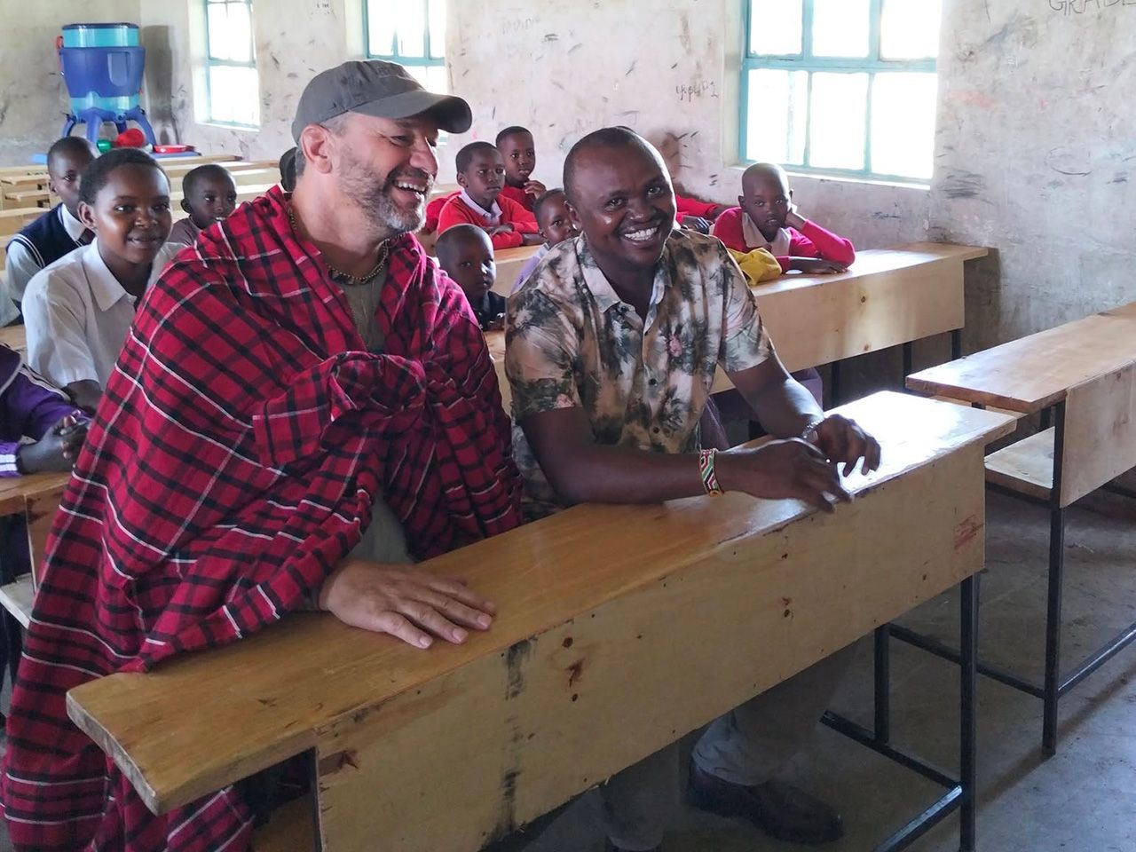 Men sitting in a classroom in village in Kenya